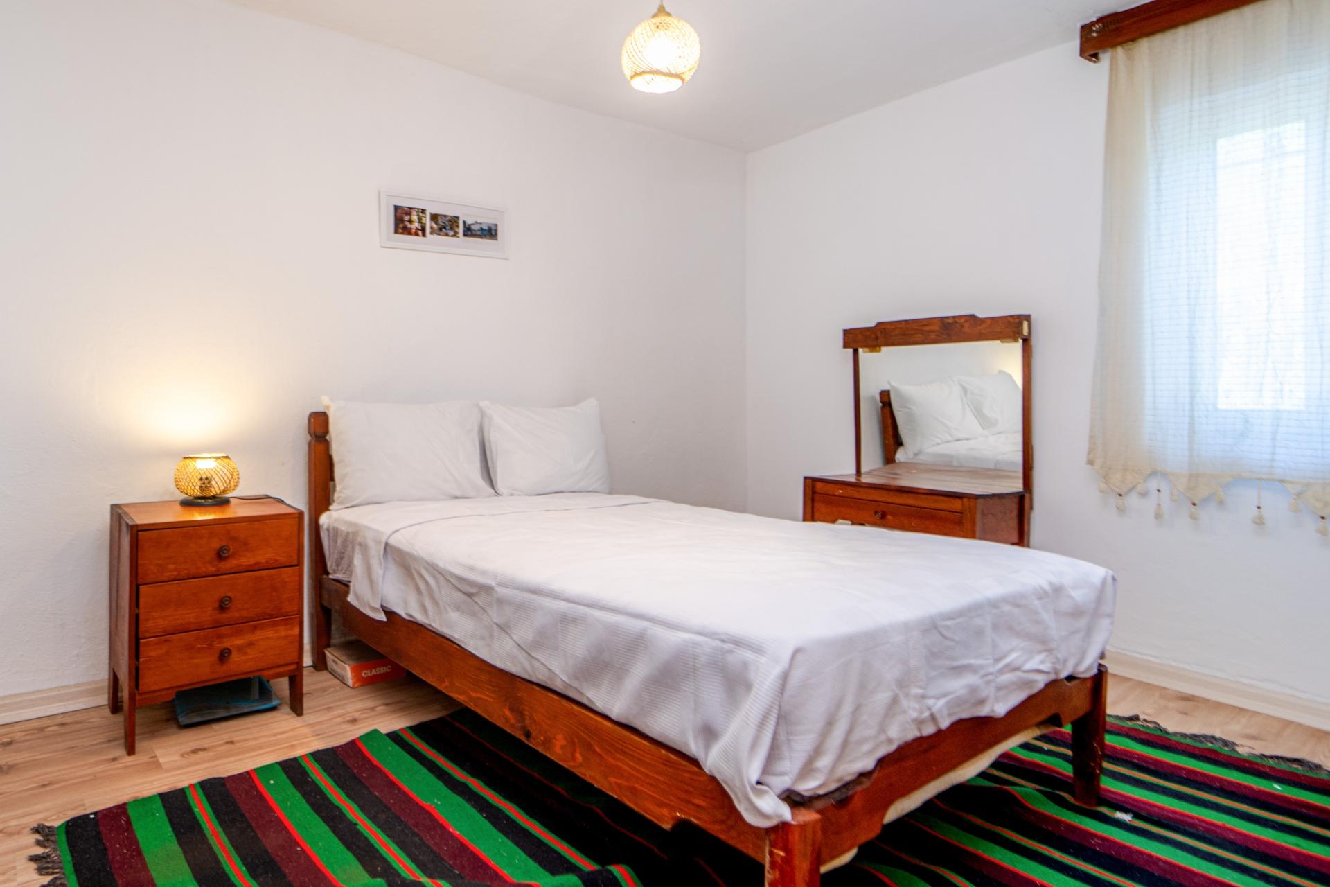 Relax and unwind in our cozy bedroom with a comfortable double bed.