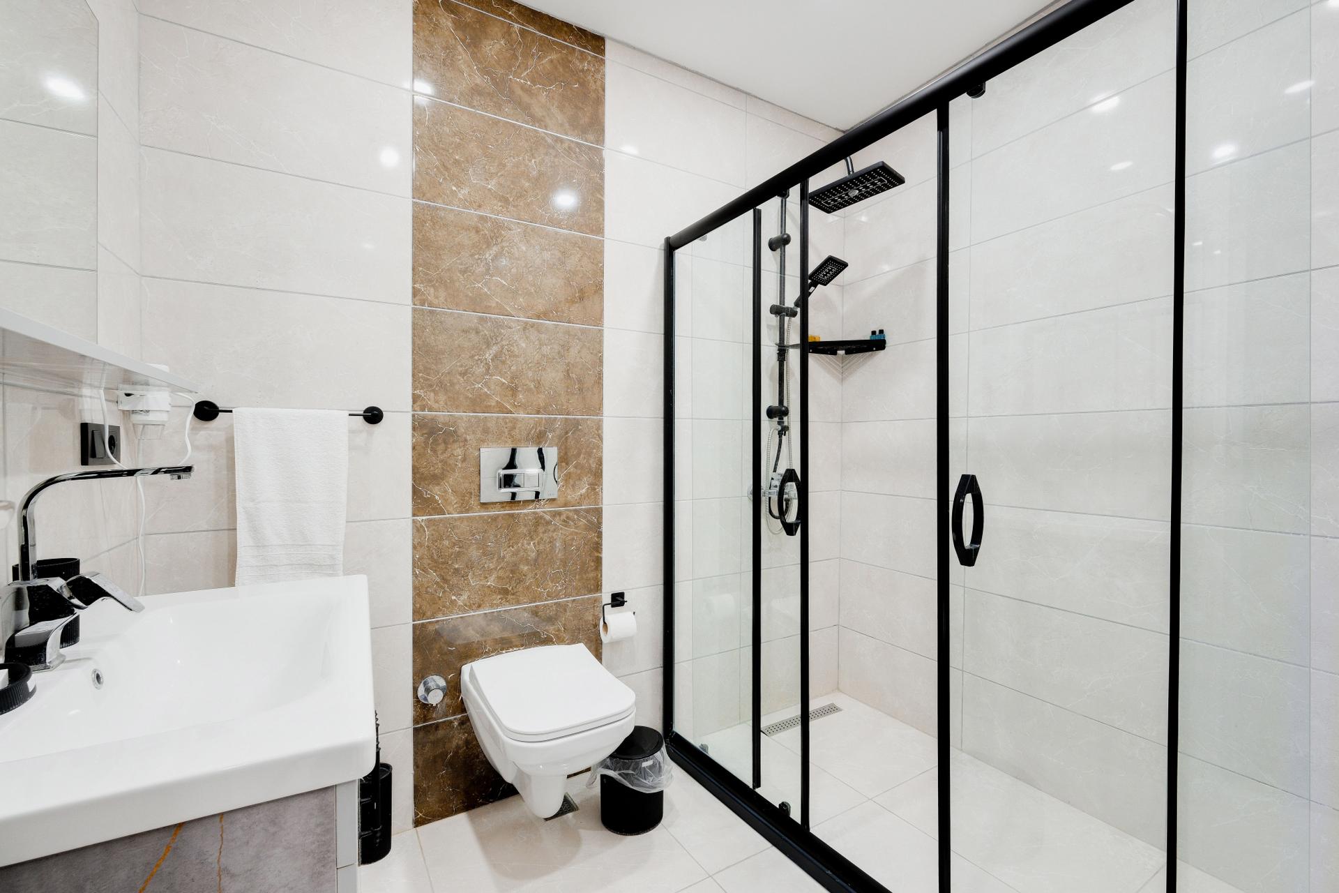 Unwind in a bathroom that provides a peaceful escape, with soft lighting and clean lines to soothe the senses.