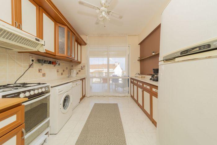 Our spacious kitchen has all the necessary white appliances and utensils.