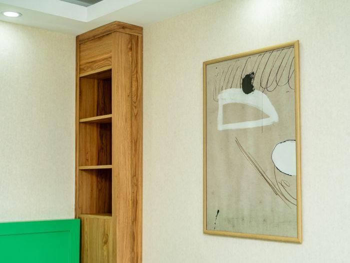 The wooden cabinet complements the room's decoration.