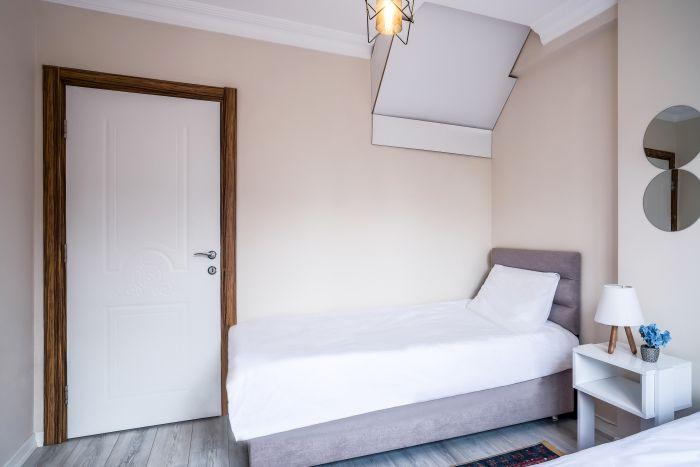 The second bedroom is equipped with two single beds.