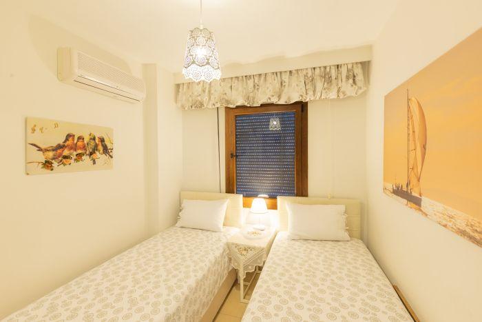 Rest and rejuvenate in our spacious bedroom with two comfortable single beds.