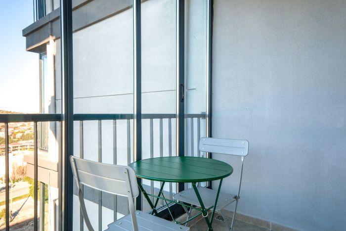 Savor the fresh air and gentle breeze on our house's balcony, a serene setting for relaxation. 