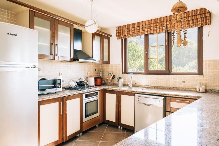 Our kitchen, with its warm tones and inviting layout, is the heart of the home.