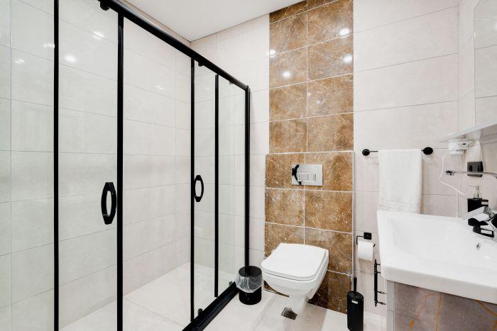 Experience the perfect blend of elegance and practicality in a bathroom designed for comfort and convenience.