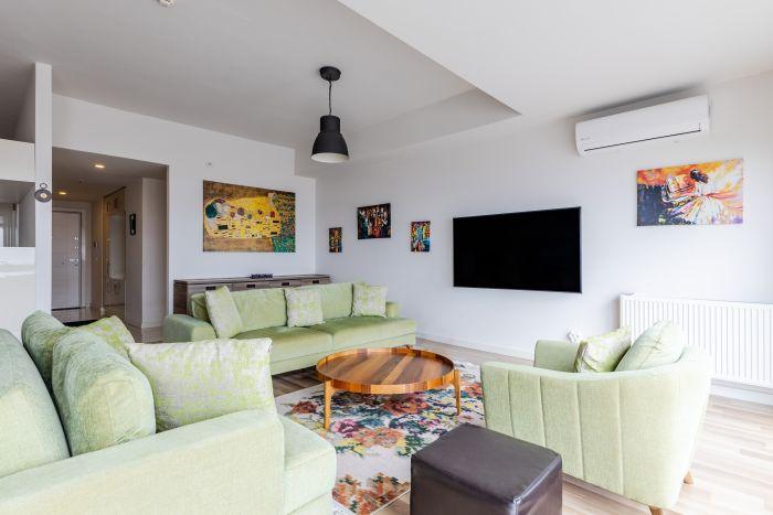 Everything is ready for perfect TV enjoyment: comfortable sofas, a large Smart TV, and AC.