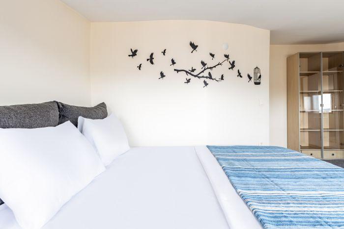 Experience a restful night's sleep in our cozy and inviting bedroom.