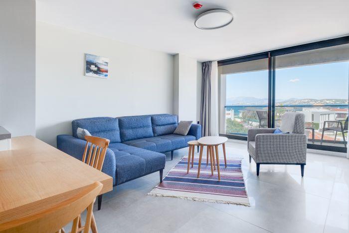 Gather, relax, and marvel: Where the sea meets comfort in our cozy living space.