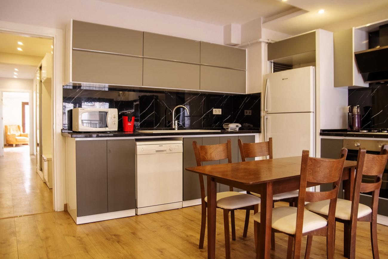 The modern open kitchen includes top-notch white goods and appliances.