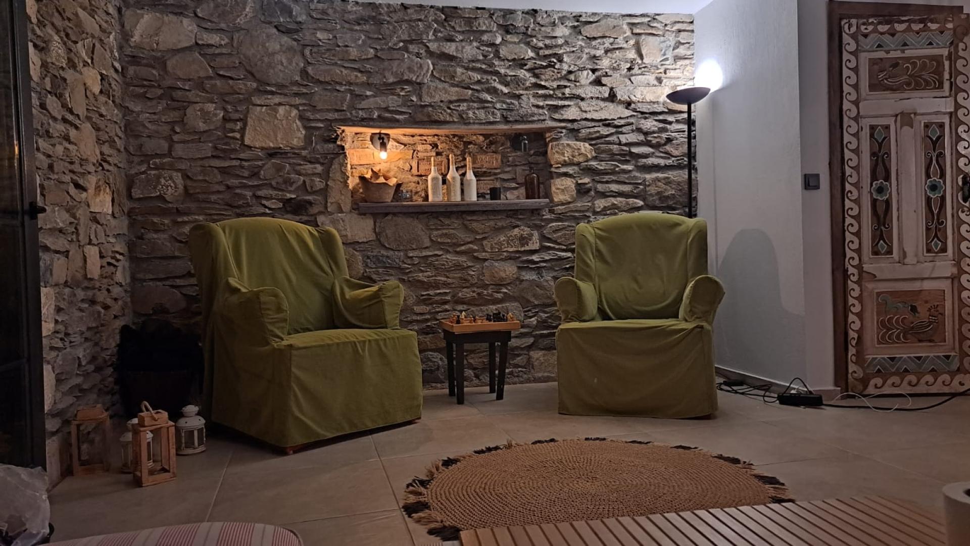 Authentic living room with stone walls will color your conversations.