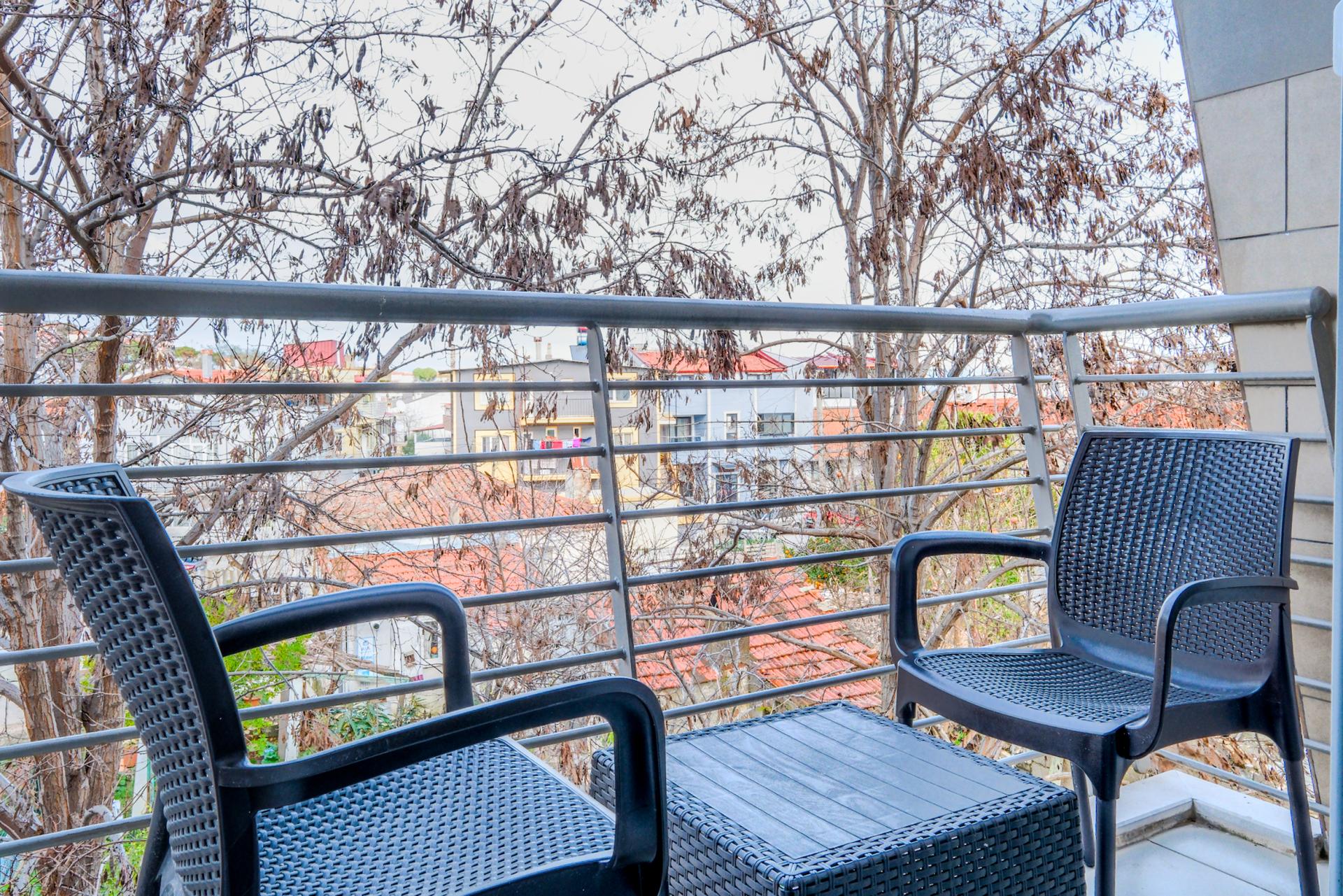 A serene balcony space, offering a breath of fresh air and a stunning view, an ideal spot for relaxation and contemplation.