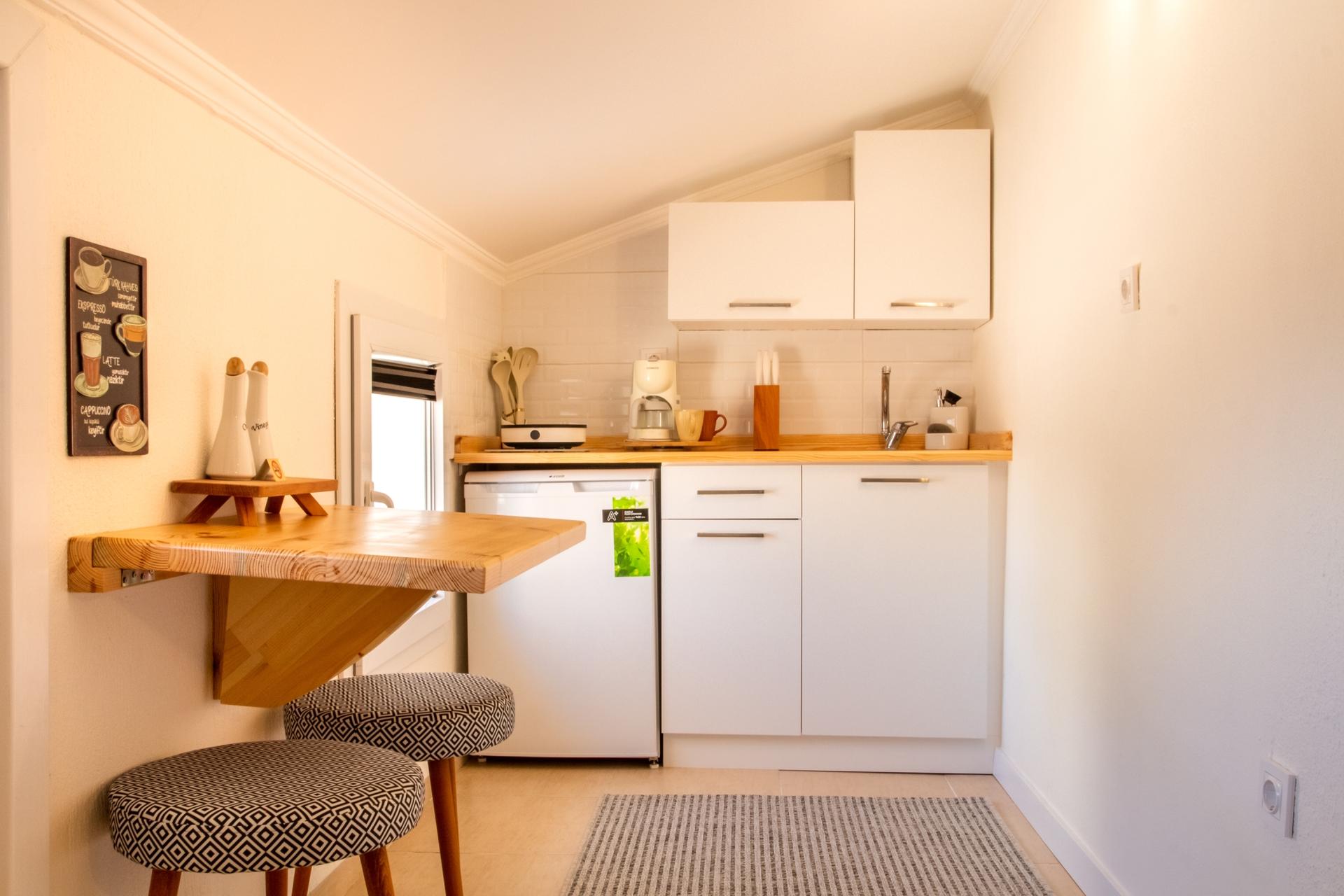 Our small but functional kitchen features modern appliances.