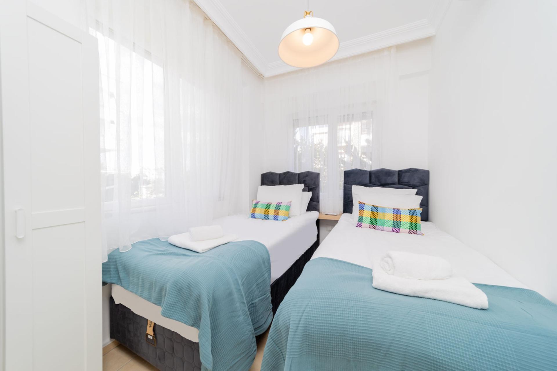 The second bedroom includes two single beds, which can be converted into a double bed.