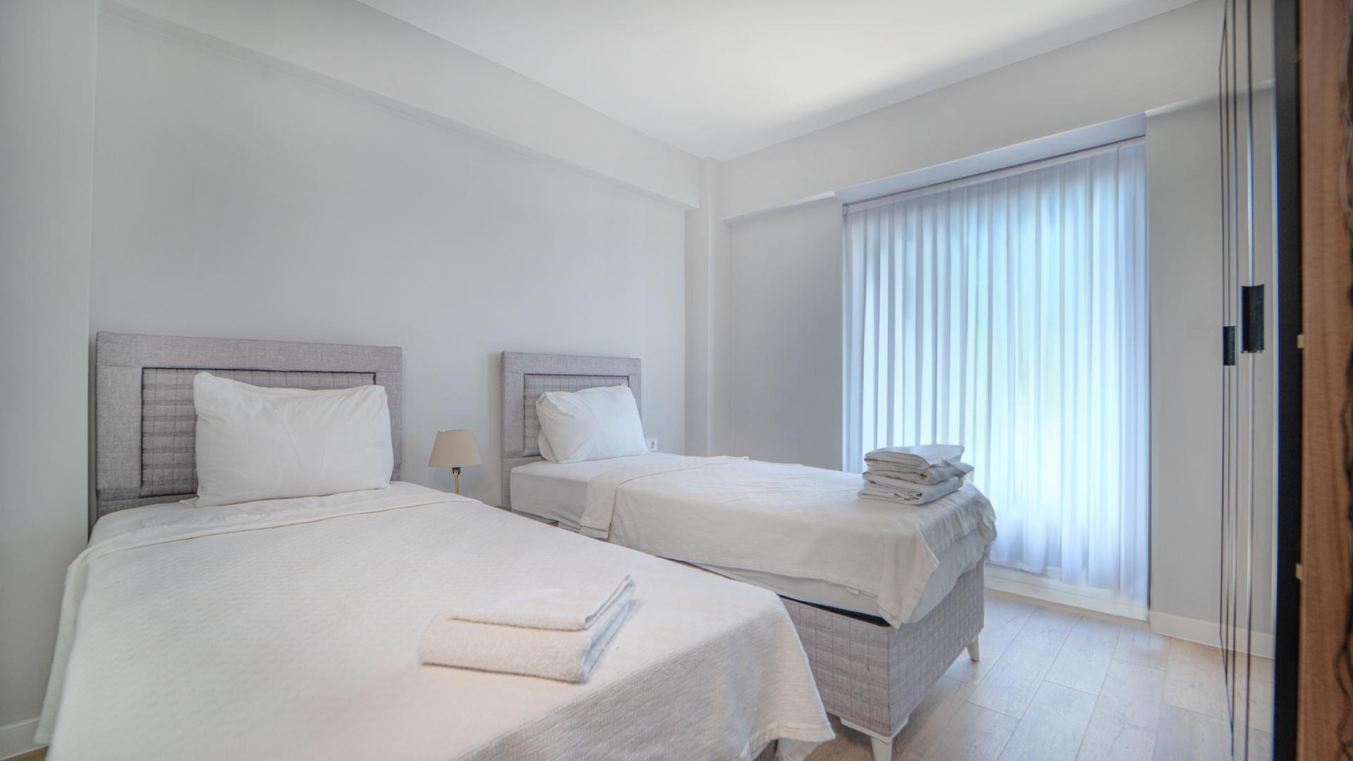 Experience a cozy and relaxing stay in our well-appointed bedroom with twin beds.