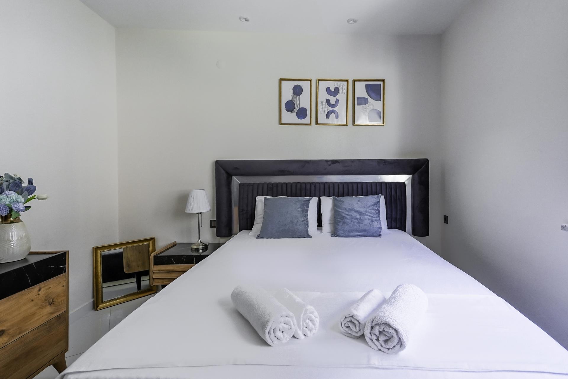 Our comfy residence flat features a bedroom with a large queen bed.