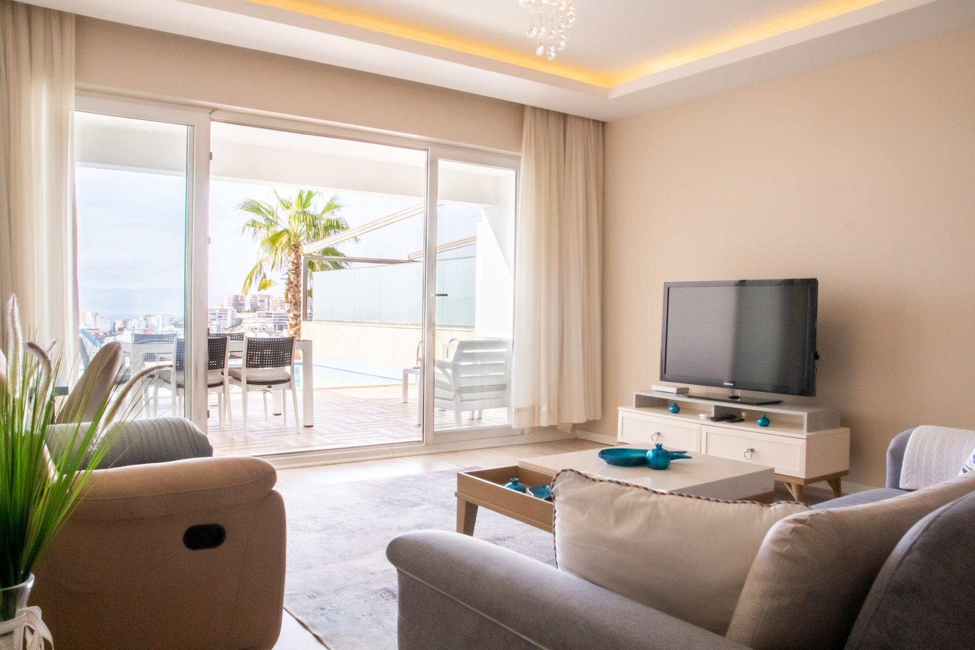 Let’s look at the living room, where you can access a private pool directly. 