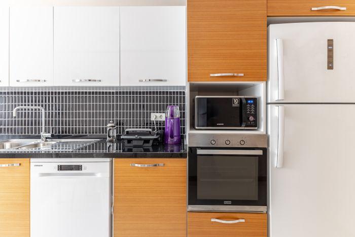 Find joy in cooking with our well-appointed kitchen, featuring modern amenities and chic design.