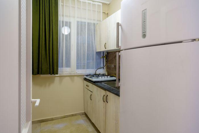 The kitchen may be small but fully furnished with all essential appliances.