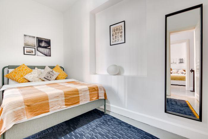 Bright and cheerful, the second bedroom serves as a comfortable retreat for guests or a productive home office.