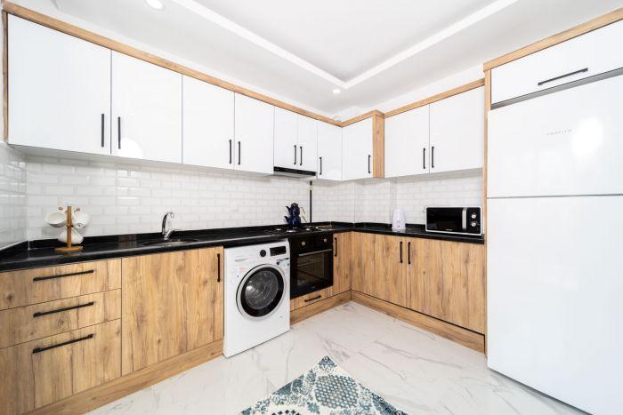 The kitchen is well equipped with modern white goods and appliances.