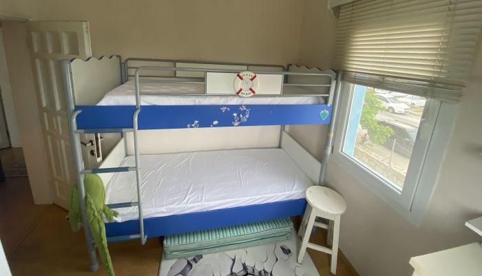In the second bedroom, an innovative bunk bed awaits, designed to maximize space and provide optimal comfort.