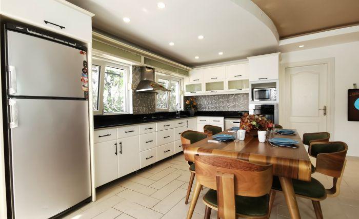 The kitchen is fully equipped with modern white goods and appliances.
