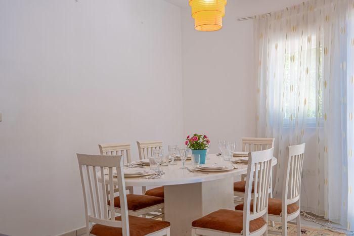Gather around our elegant dinner table in the heart of the living room .