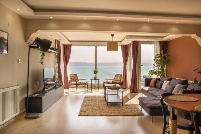 The bright living room is facing the legendary Aegean Sea.