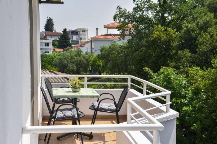 Savor the fresh air and gentle breeze on our house's balcony, a serene setting for relaxation. 