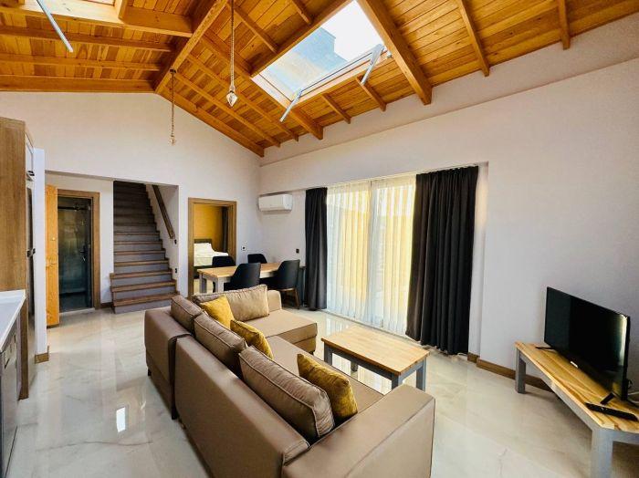 Let's look at the villa's interior, where you will find a spacious living room with a moonroof.