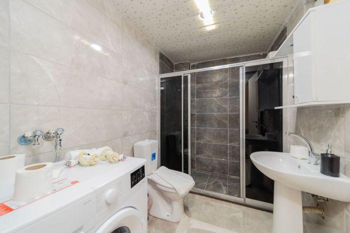 The functional bathroom includes a hot shower for refreshment and hygienic products.