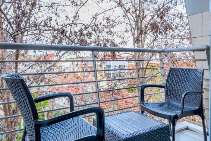 A serene balcony space, offering a breath of fresh air and a stunning view, an ideal spot for relaxation and contemplation.