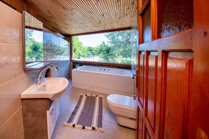 Our refreshing bathroom has bright tiles, useful toiletries, enough storage space, and an amazing view.