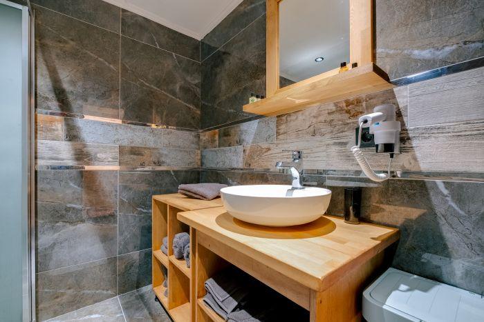 A bathroom retreat that mirrors a luxury spa with its soothing tones, elegant fixtures, and a rejuvenating shower.