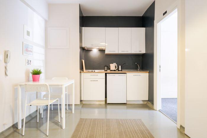 A modern and sleek kitchen, complete with stainless steel appliances and a spacious countertop, ready for culinary adventures and delightful cooking experiences.