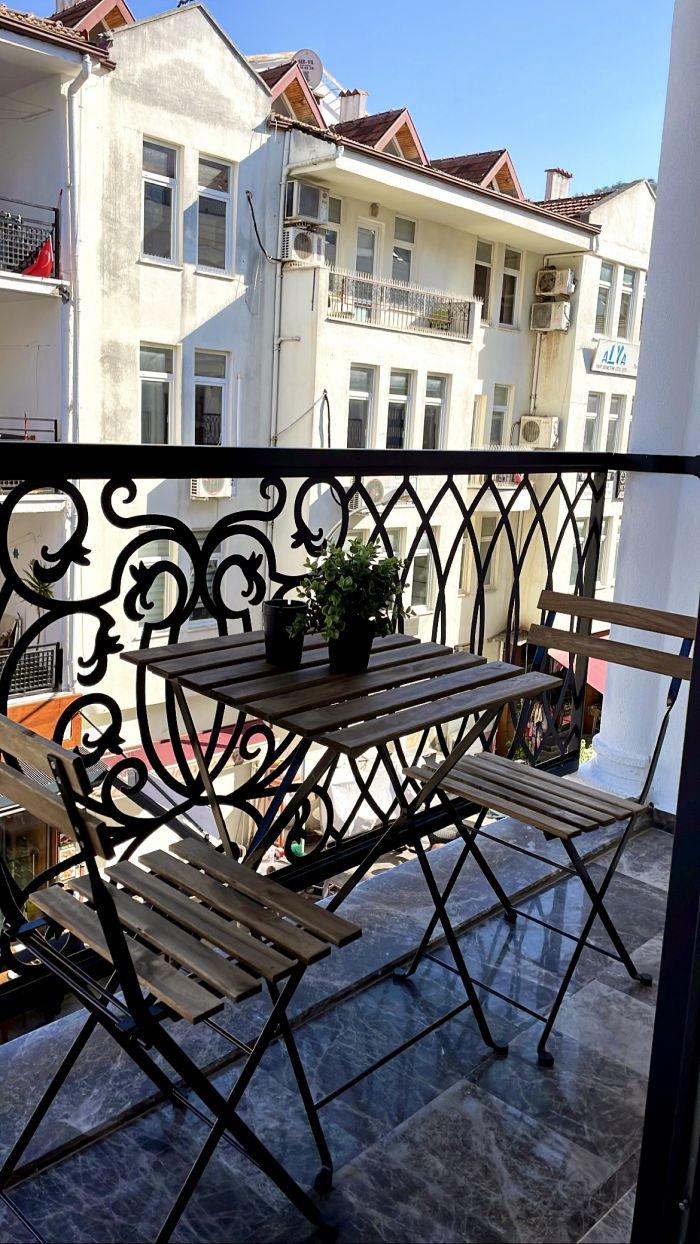 Enjoy morning coffee or evening drinks on our house's private balcony, a delightful space for relaxation.