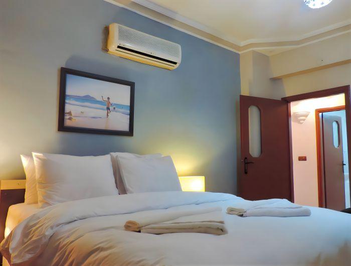 Our spacious bedroom also features an AC in use.