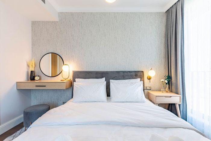 Our neat and chic bedroom includes a comfy double bed.