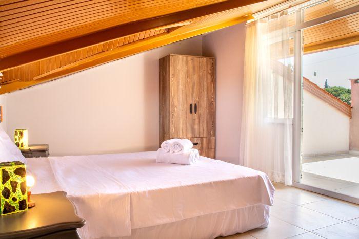 A space that breathes inspiration - our double bedroom with artistic touches and the comfort of wooden walls.
