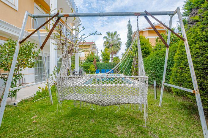 You are invited to enjoy the hammock swing in its lush garden.