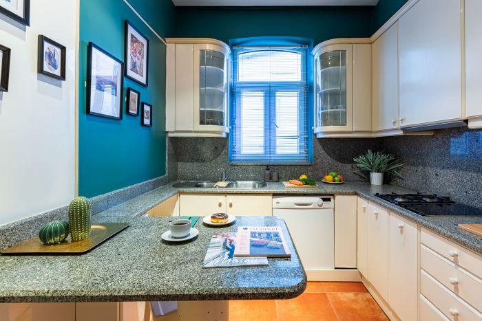 The kitchen is colorful, modern and well-equipped.