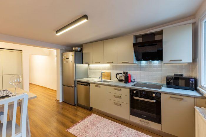 The kitchen is quite spacious and modernly designed.