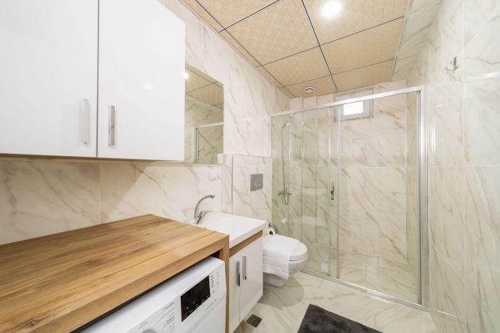 You will find the washing machine in our modern, sleek and hygienic bathroom.