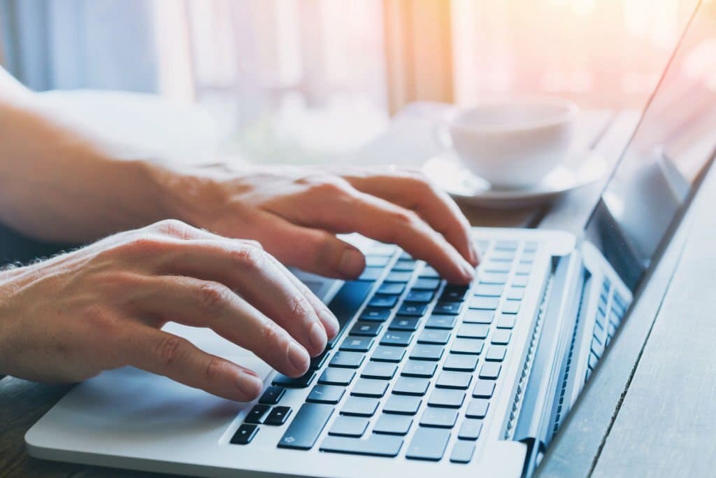 hands on notebook computer, airbnb login page